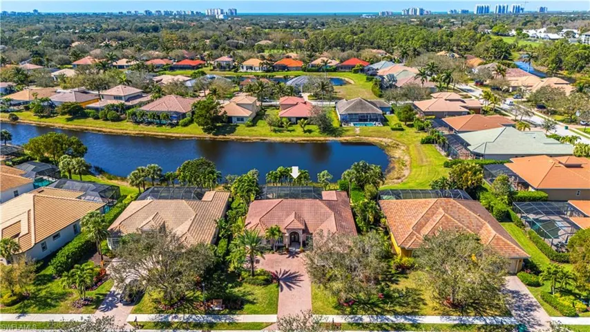 Birds eye view of property featuring a water view and a residential view