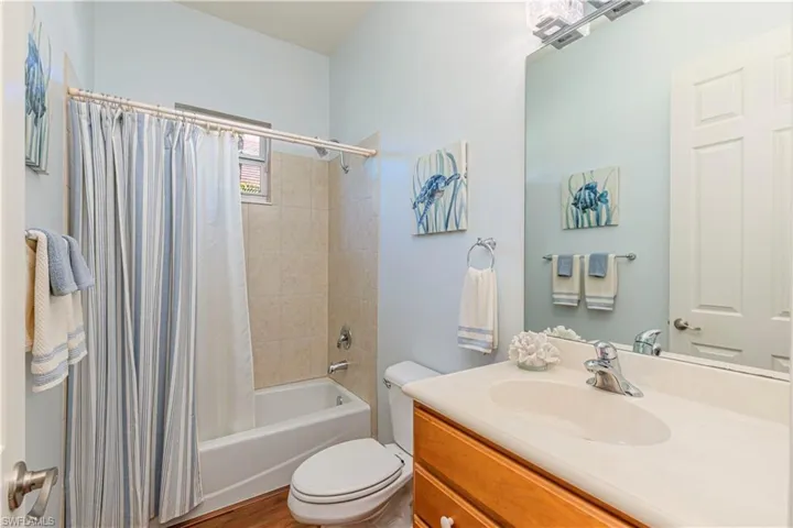 Full bath with toilet, shower / bath combo, and vanity