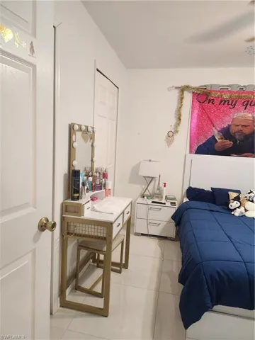 Bedroom featuring light tile flooring