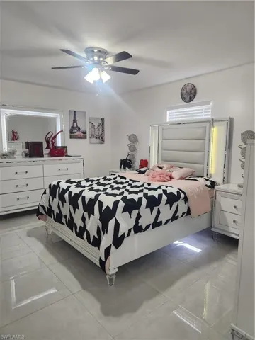 Tiled bedroom with ceiling fan
