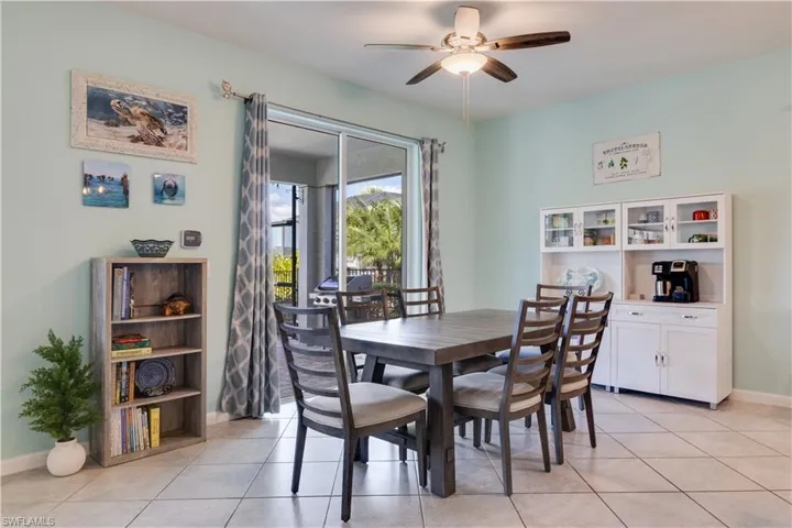 Dining area with sliding door to a covered, screened lanai.