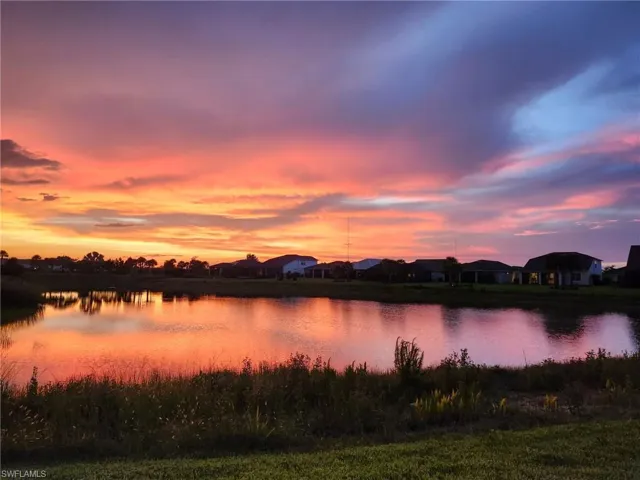 Expansive pond lakefront property with a natural grass and brush shoreline