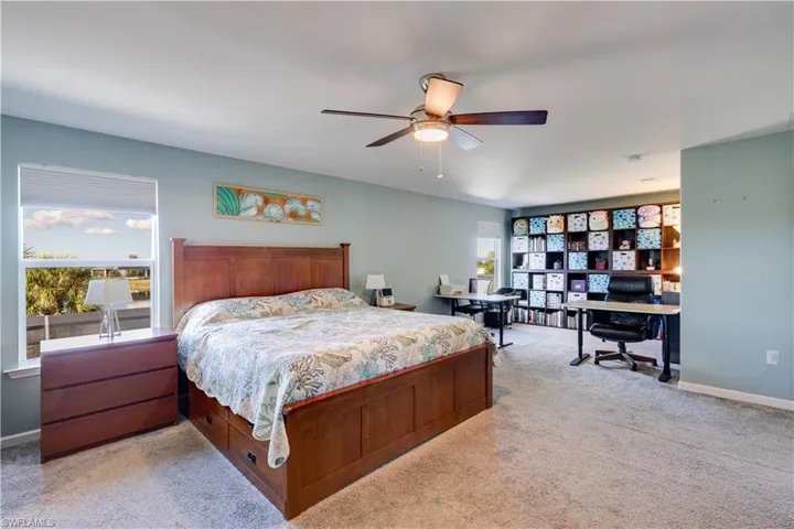 Spacious bedroom featuring sitting area