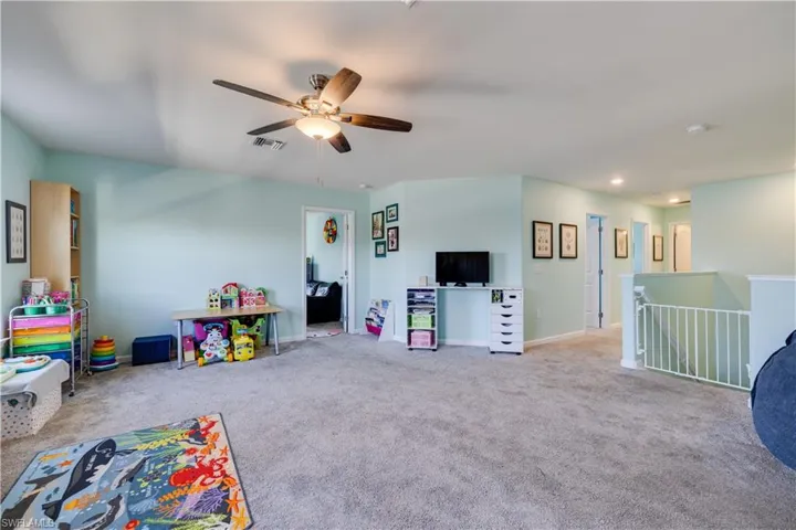Spacious bonus room featuring vaulted ceilings, recessed lighting, and a ceiling fan