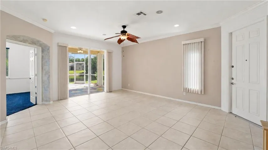 Spacious interior with tile flooring and a ceiling fan