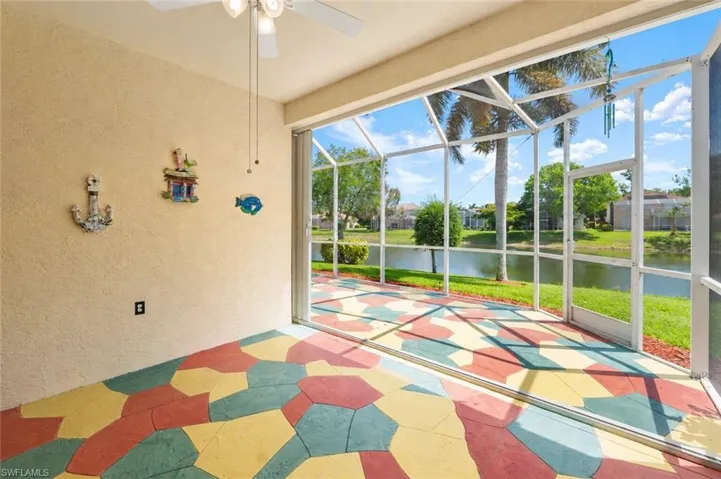 Screened lanai featuring a multicolored geometric pattern on the concrete flooring