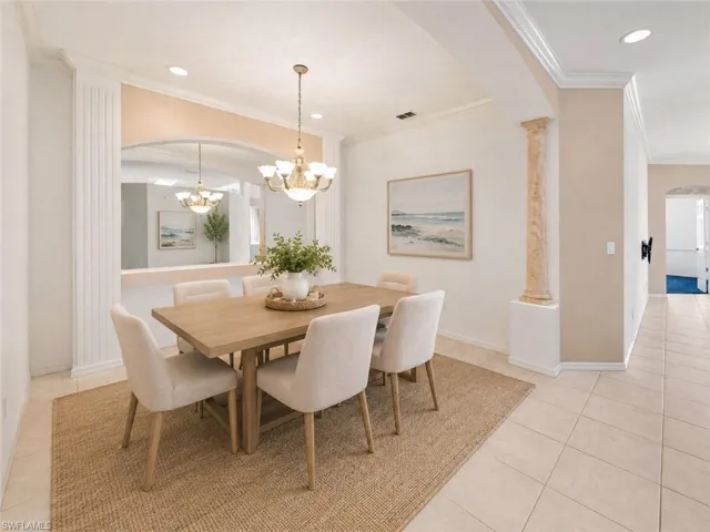 Dining area featuring a wood-finish table with upholstered chairs, set on a natural fiber area rug