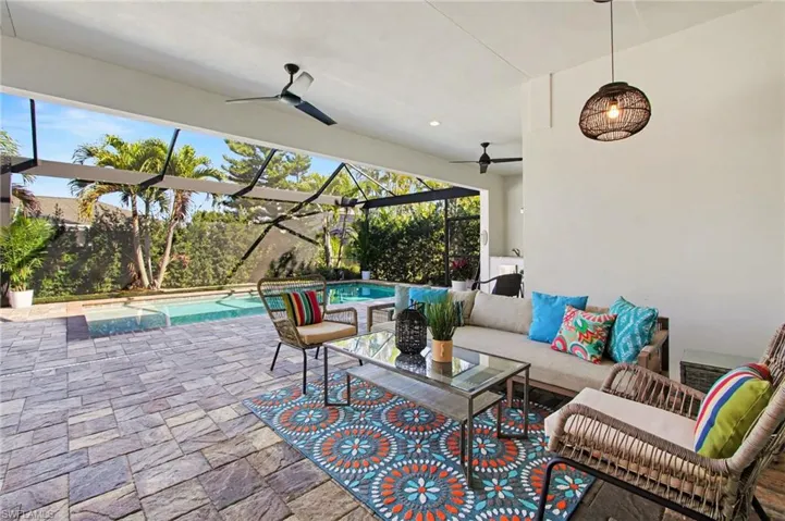 View of patio / terrace featuring outdoor lounge area, an outdoor pool, ceiling fan, a lanai, and a sunroom