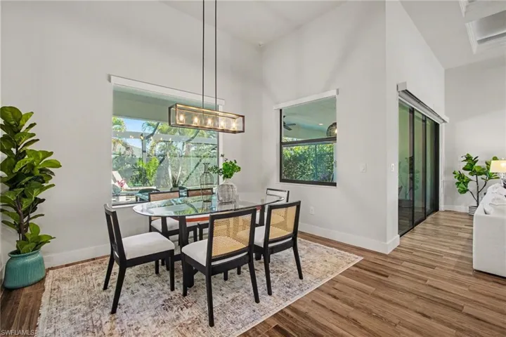 Dining area with wood finished floors and plenty of natural light