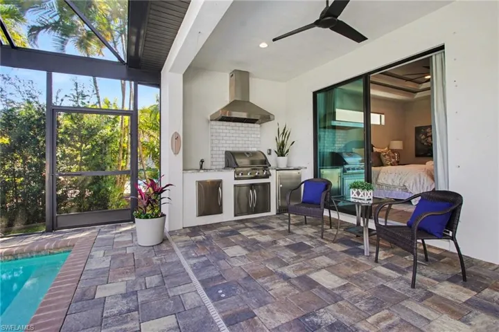 View of patio / terrace with area for grilling, a sunroom, ceiling fan, an outdoor pool, and a lanai