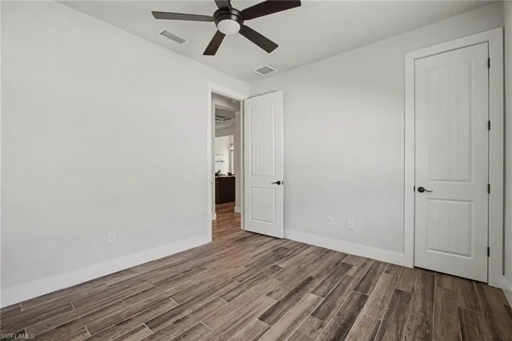 Unfurnished bedroom featuring wood finish floors and a ceiling fan