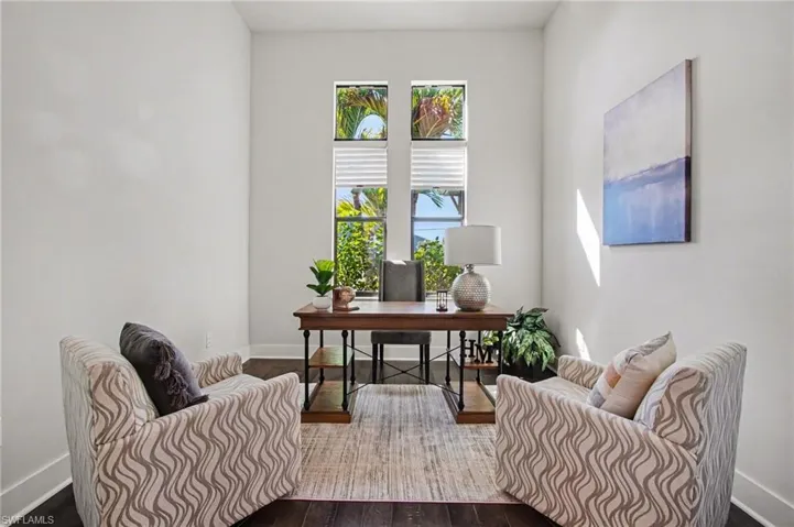 Office space with baseboards and dark wood-style floors