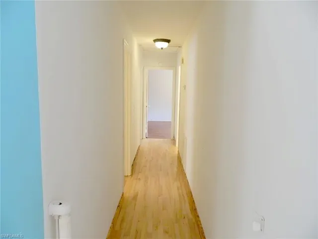 Hallway with light wood-style flooring