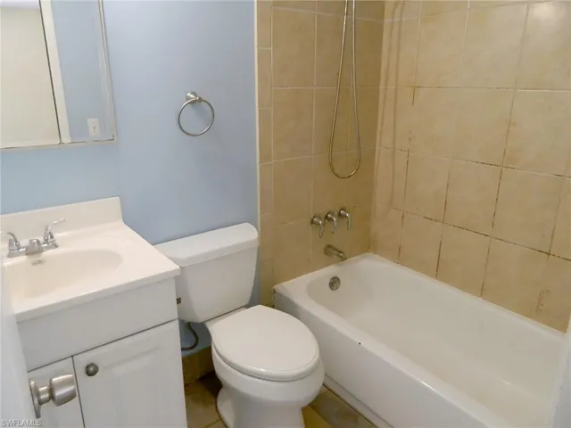 Bathroom with vanity, toilet, and shower / bathtub combination
