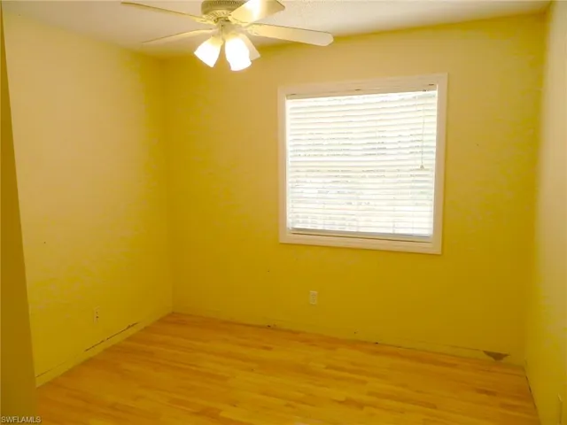 Empty room featuring light wood-type flooring and ceiling fan