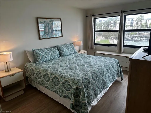 Bedroom with dark hardwood / wood-style flooring
