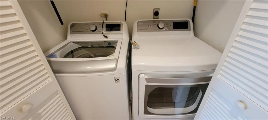 Washroom featuring washing machine and dryer