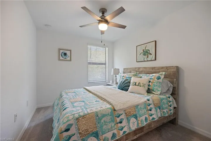 Carpeted bedroom with ceiling fan