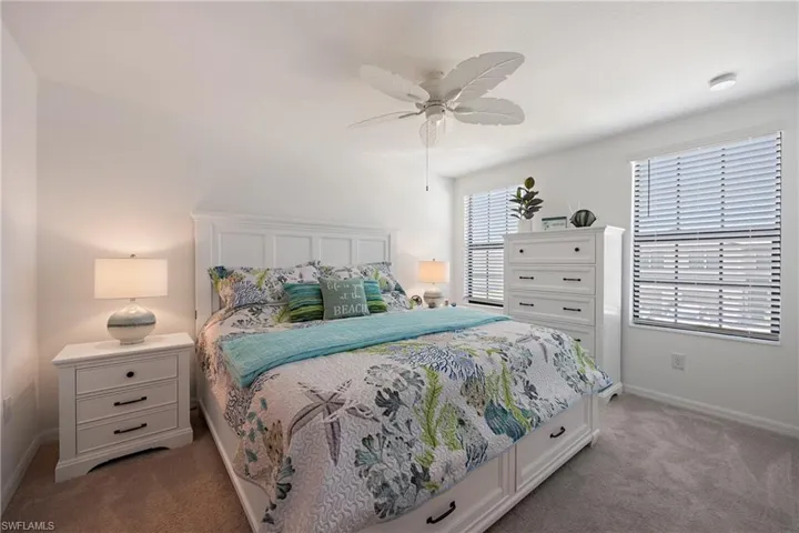 Bedroom with light carpet and ceiling fan
