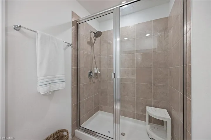 Bathroom featuring a shower with door