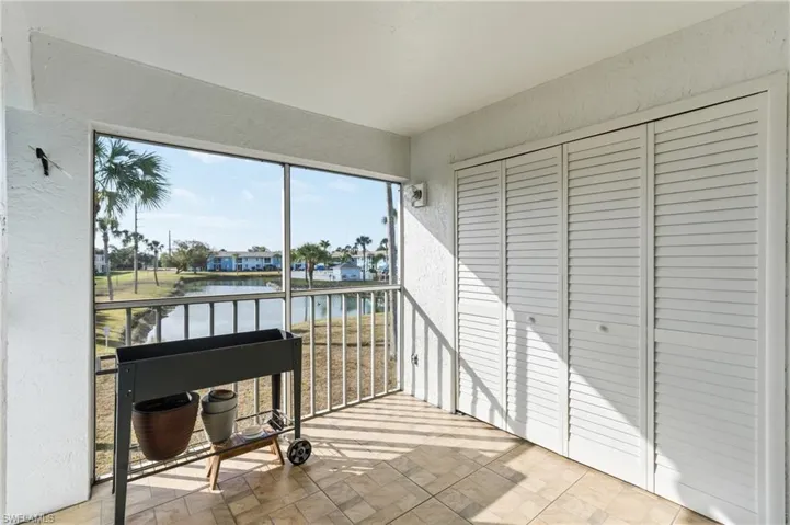 Sunroom / solarium featuring a water view
