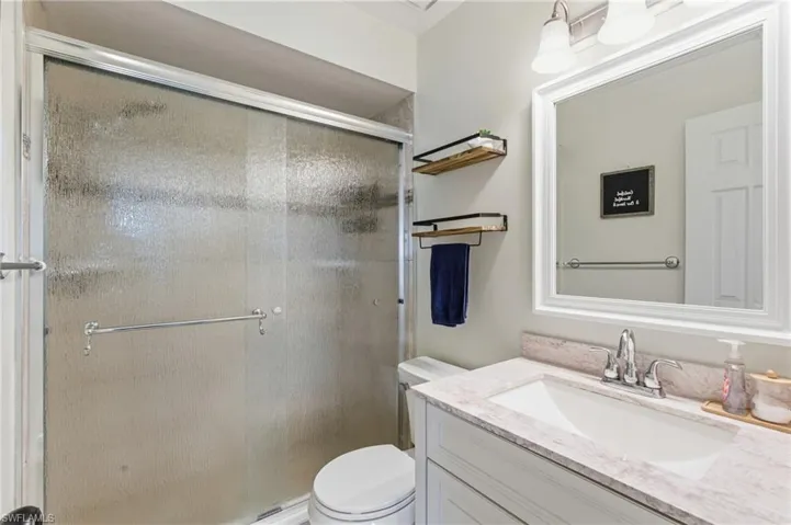 Full bath featuring vanity and a stall shower