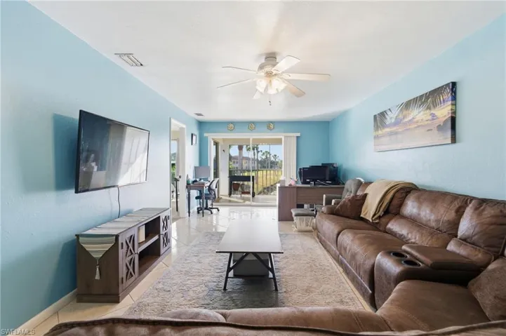 Tiled living area featuring an office area and ceiling fan