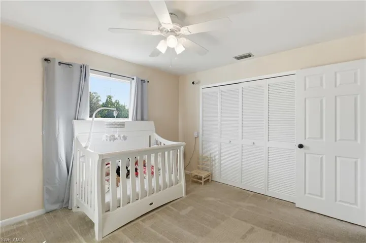 Bedroom with carpet floors, a closet, and a ceiling fan