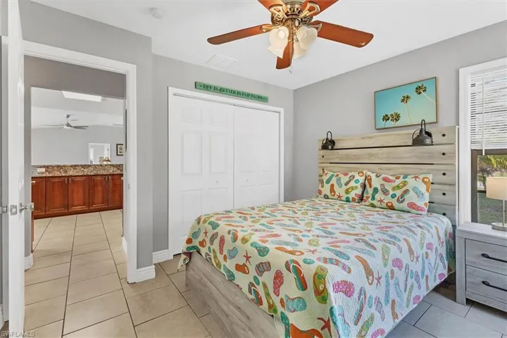 Bedroom featuring light tile patterned floors, a closet, visible vents, and ceiling fan