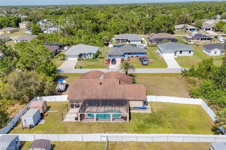 Drone / aerial view featuring a wooded view and a residential view