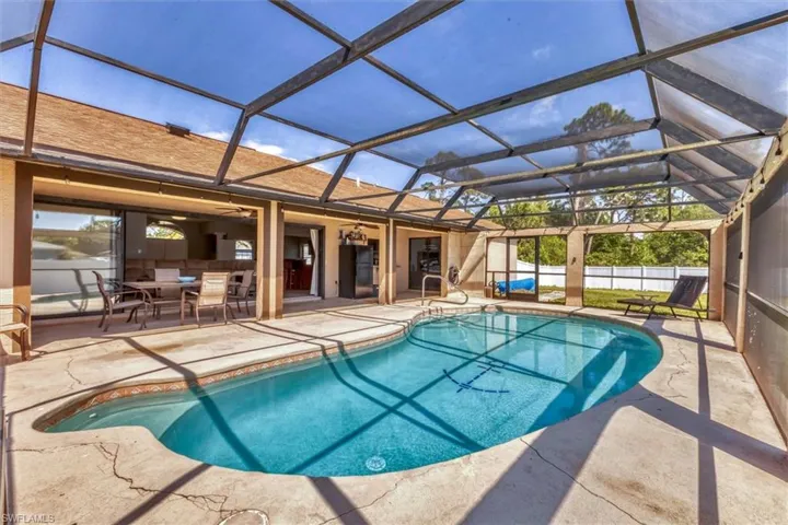 View of pool with a fenced in pool, a patio, and fence