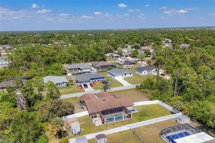 Drone / aerial view featuring a residential view and a wooded view