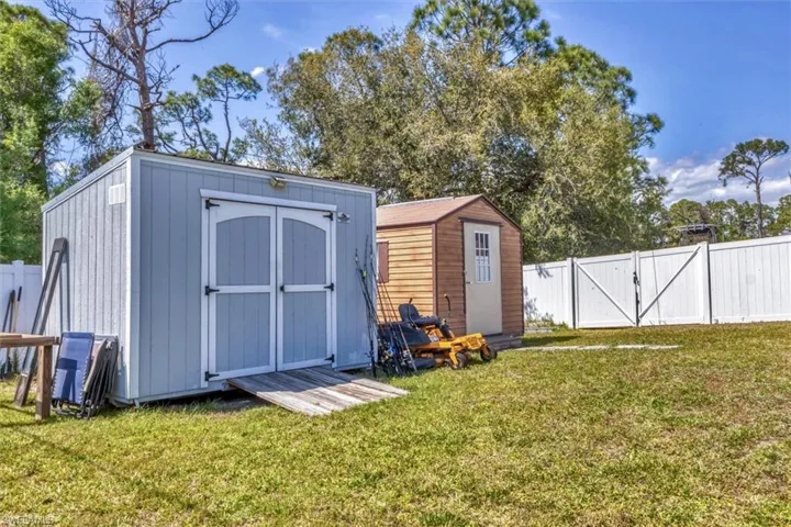 View of shed with a gate and a fenced backyard