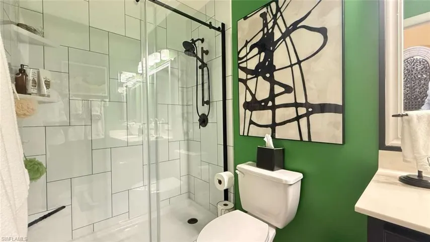 Full bath with a stall shower and vanity