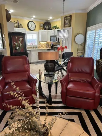 Living area with ornamental molding and recessed lighting