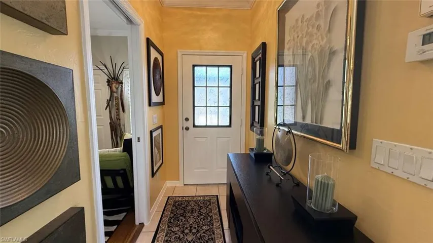 Doorway to outside featuring light tile patterned floors