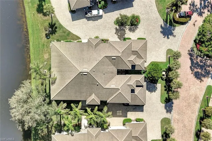 Birds eye view of property with a water view