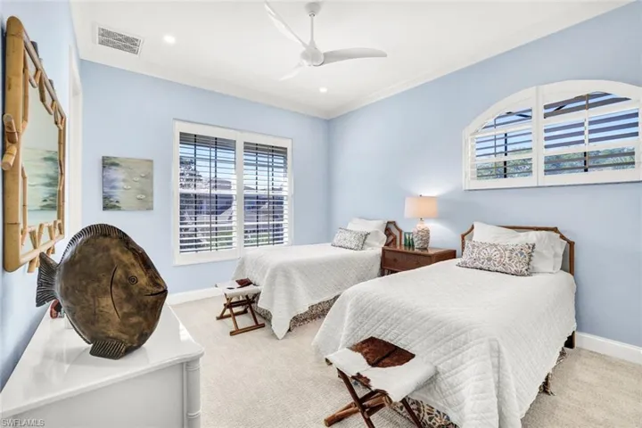 Bedroom featuring crown molding, ceiling fan, and light carpet
