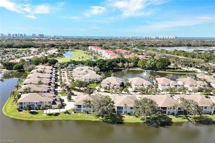 Birds eye view of property with a water view