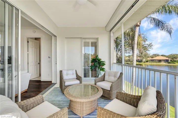 Sunroom / solarium featuring a water view and ceiling fan