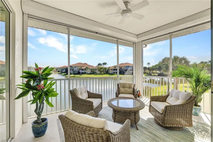 Sunroom / solarium featuring a water view, a healthy amount of sunlight, and ceiling fan