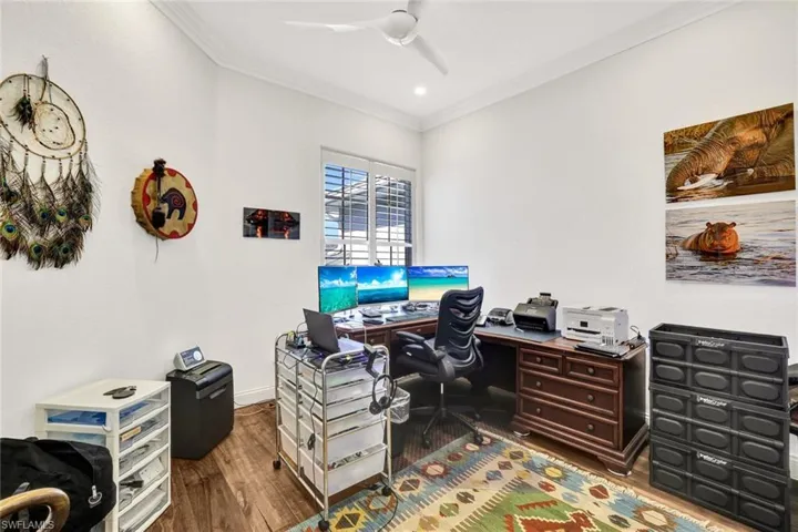 Office featuring hardwood / wood-style flooring, crown molding, and ceiling fan