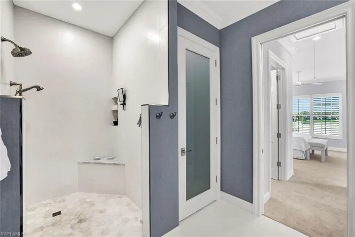 Bathroom with walk in shower and ornamental molding