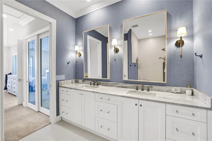 Bathroom featuring vanity, crown molding, and french doors