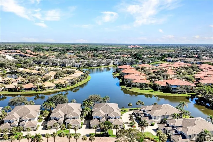 Birds eye view of property with a water view