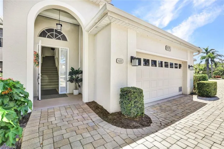 View of exterior entry with a garage