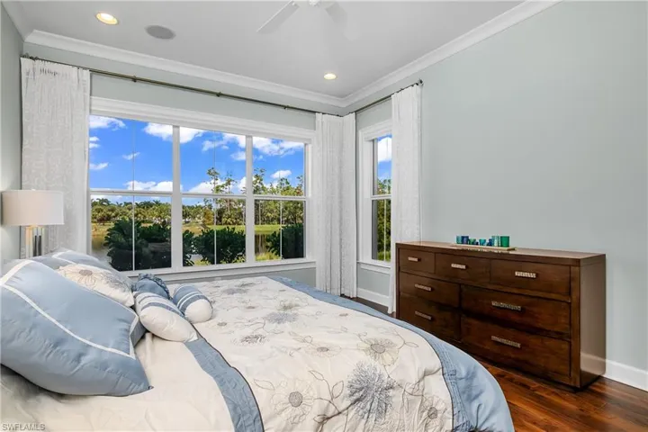 Owner's Bedroom featuring ceiling fan, hardwood / wood-style floors, and crown molding, Large windows with electric shades. Whole house sound system.