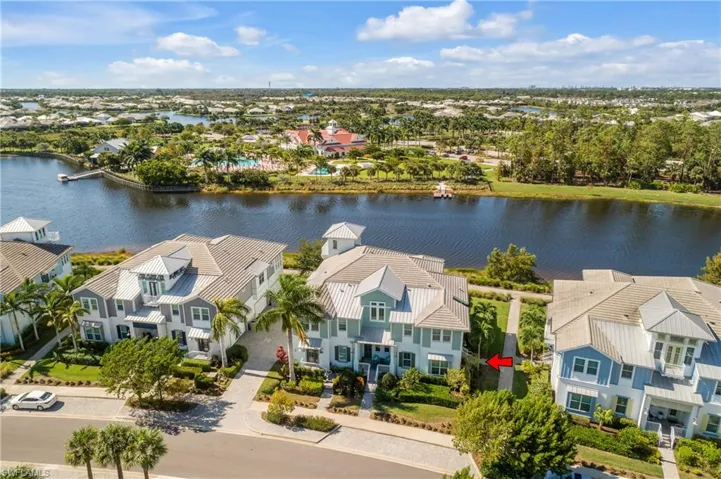 Birds eye view of property with a water view. Note the kayak launch, clubhouse in the background.