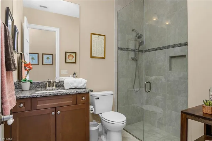 Guest Bathroom with vanity, toilet, and a shower with a Frameless Glass door.