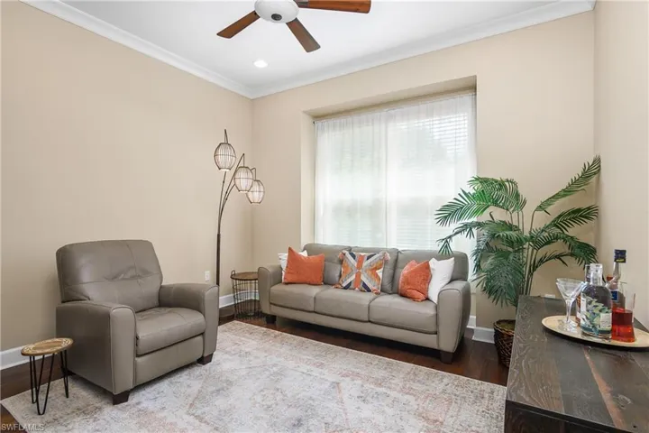 Den / Office / Flex room with a wet bar, could be a media room, you pick! Ceiling fan, crown molding, and hardwood / wood-style floors. Large side by side windows.